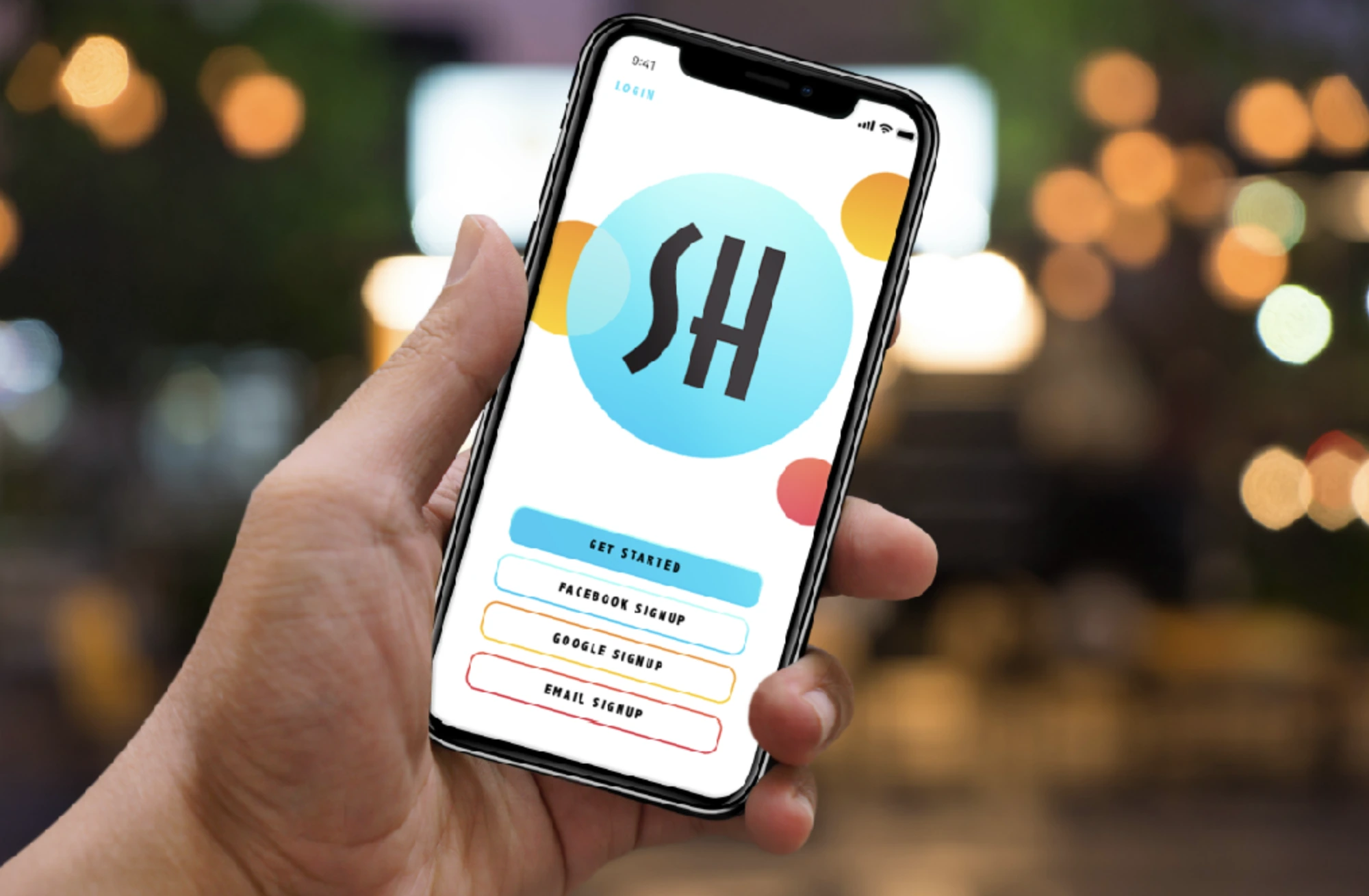 SH sign-in screen held in a hand