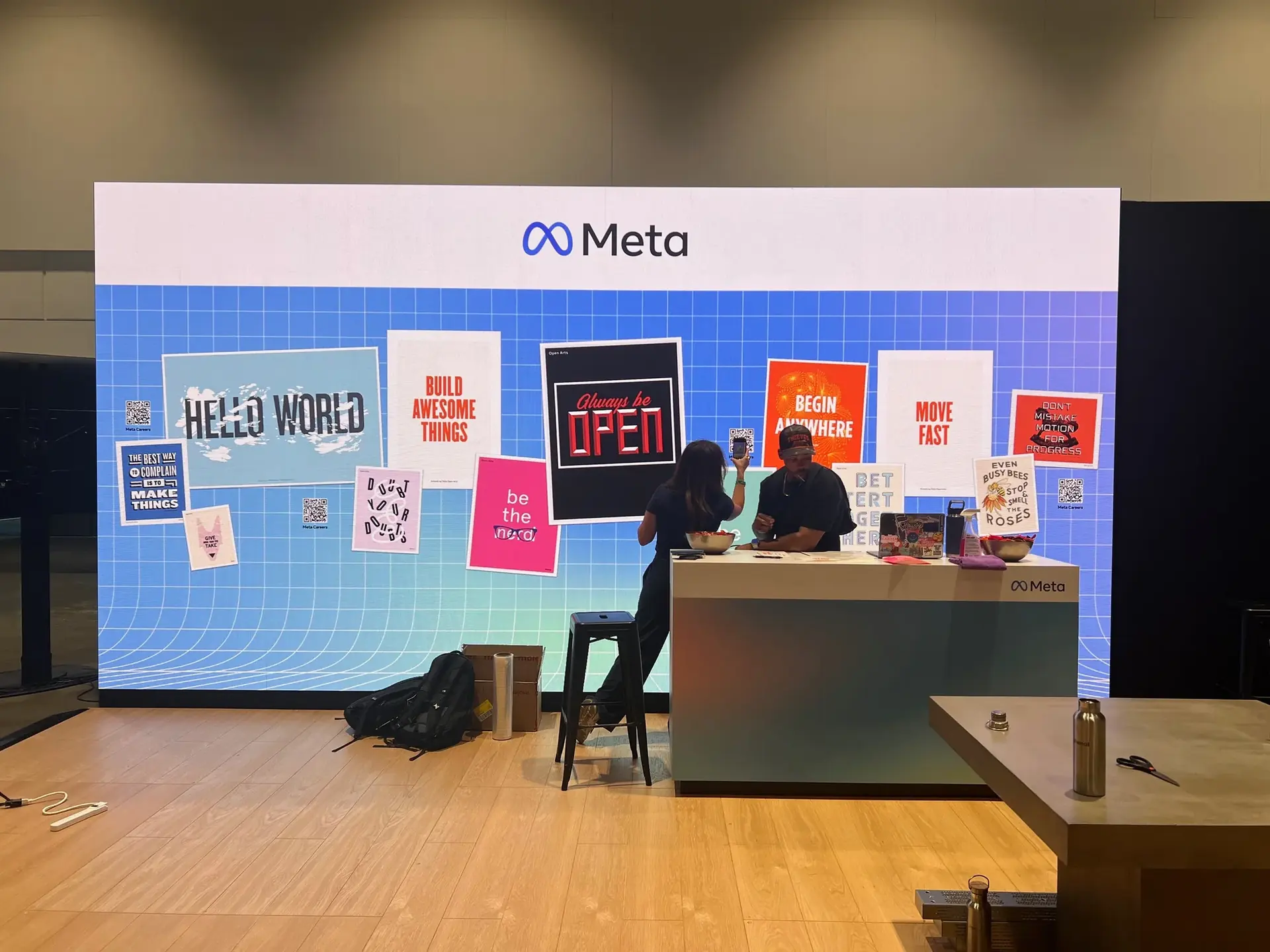 Meta booth at an infrastructure event, with an LED wall of Open Arts posters